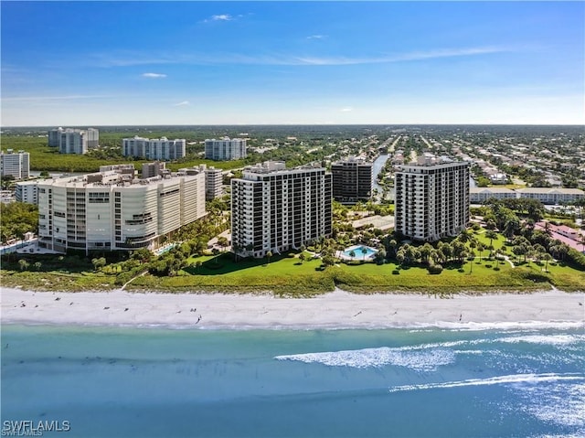 birds eye view of property with a water view and a beach view