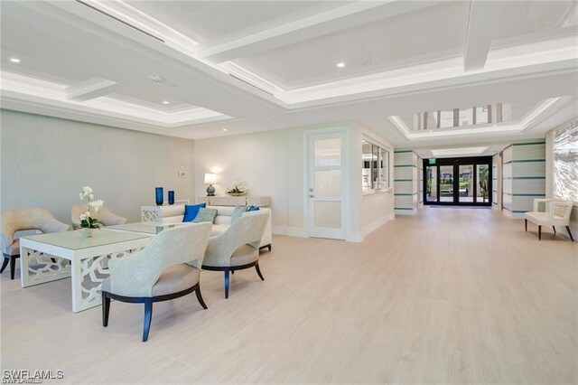 living room featuring coffered ceiling, ornamental molding, beam ceiling, and light hardwood / wood-style floors