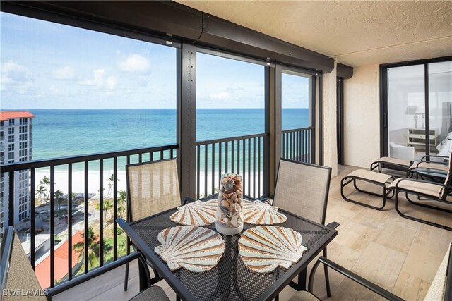 balcony with a water view and a beach view