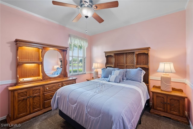 bedroom with dark colored carpet and a ceiling fan