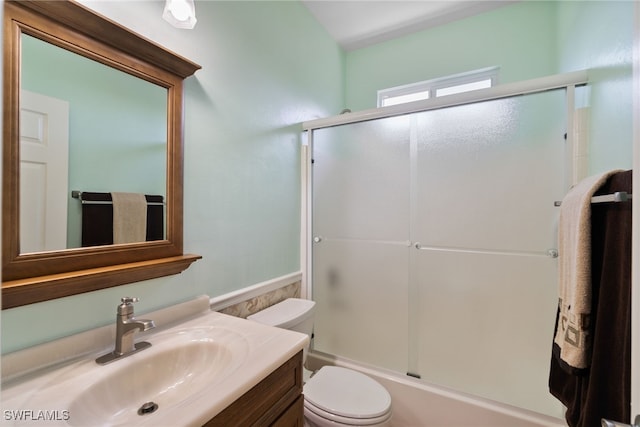 full bathroom featuring shower / bath combination with glass door, vanity, and toilet