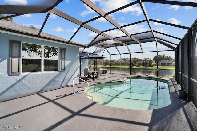 outdoor pool featuring a patio area, a water view, and a lanai