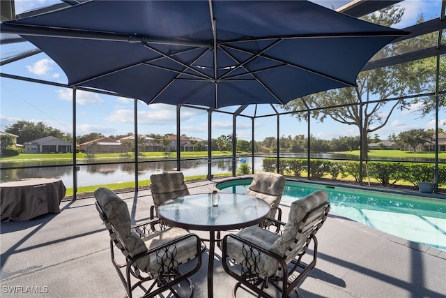 view of patio / terrace featuring glass enclosure, a water view, and an outdoor pool