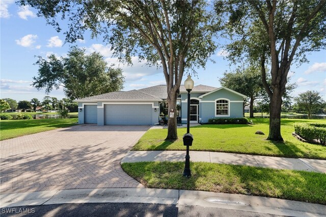 ranch-style house featuring a garage and a front yard