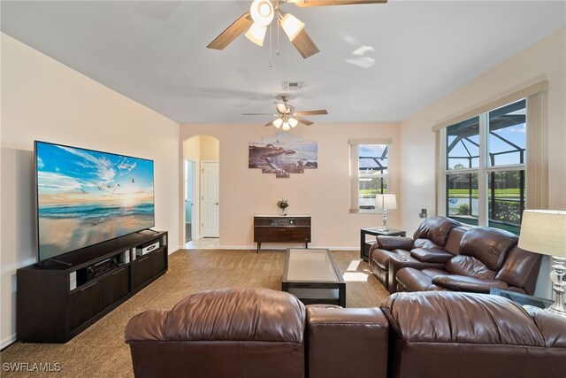 carpeted living room featuring ceiling fan