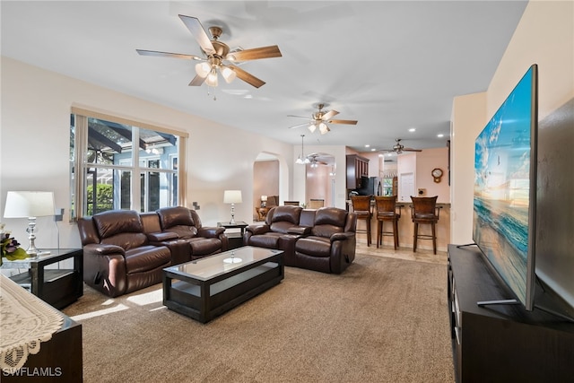 living room with carpet floors and arched walkways