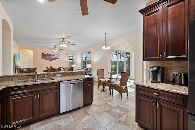 kitchen with tasteful backsplash, visible vents, hanging light fixtures, stainless steel dishwasher, and a sink