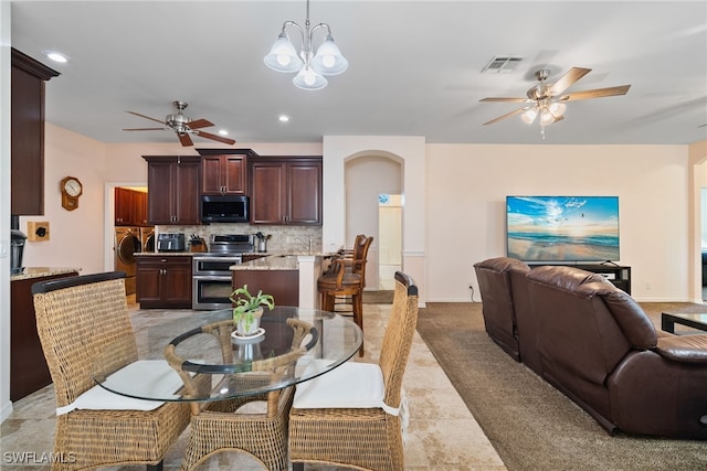 dining room with washer / dryer, visible vents, light colored carpet, ceiling fan with notable chandelier, and recessed lighting