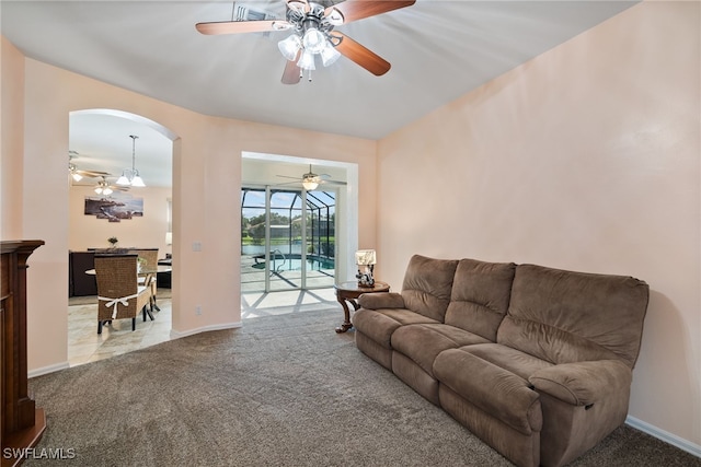 living area with light carpet and baseboards