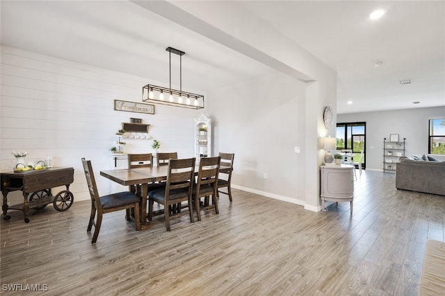 dining space with recessed lighting, wood finished floors, visible vents, and baseboards