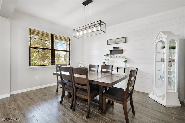 dining space featuring baseboards and dark wood-style flooring