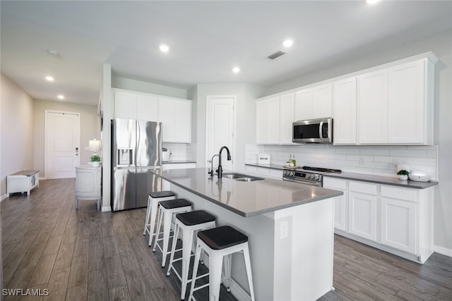 kitchen with stainless steel appliances, white cabinets, and a sink