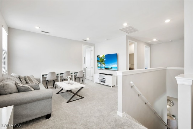 living area featuring recessed lighting, light colored carpet, visible vents, and baseboards