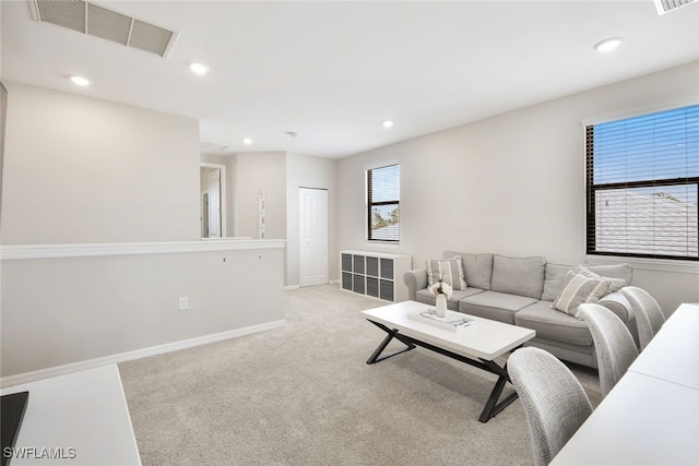 living area featuring light carpet, recessed lighting, visible vents, and baseboards