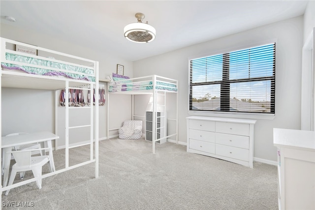 unfurnished bedroom featuring light carpet and baseboards