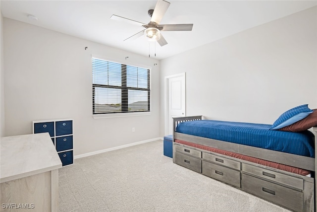 bedroom with baseboards, a ceiling fan, and light colored carpet