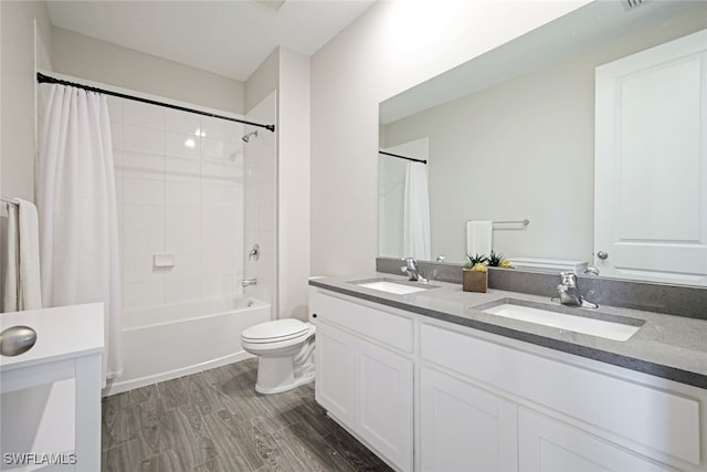 full bathroom featuring wood finished floors, shower / bath combination with curtain, double vanity, and a sink