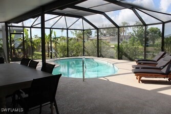 pool featuring a lanai and a patio area
