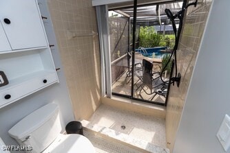 bathroom with walk in shower and toilet