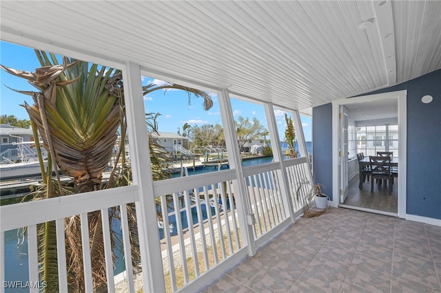 unfurnished sunroom with a water view