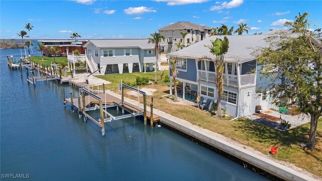 dock area featuring a water view and a yard