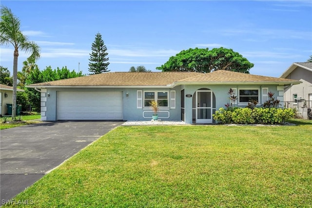 ranch-style house with a garage and a front lawn