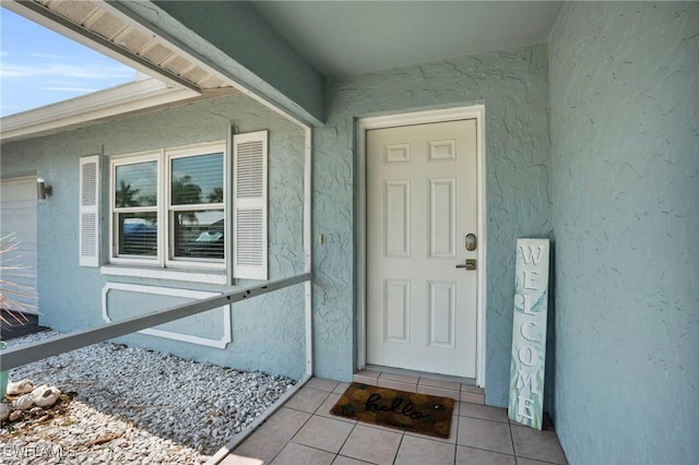 entrance to property featuring stucco siding