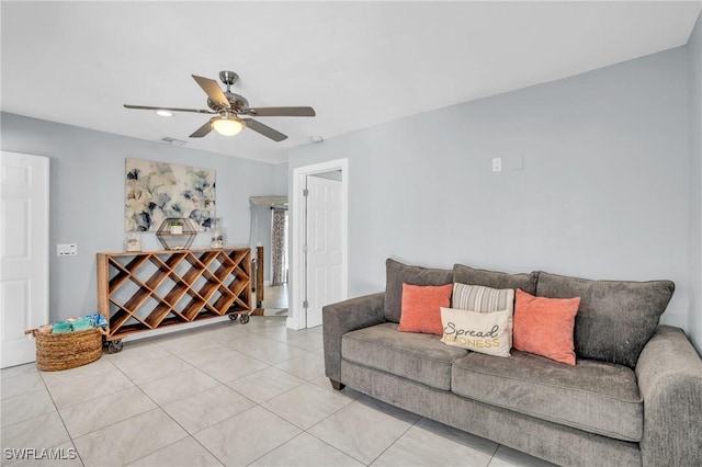 tiled living room with ceiling fan