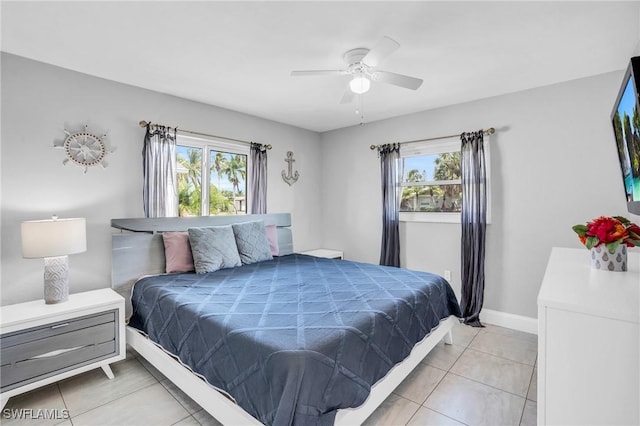 bedroom with multiple windows, light tile patterned flooring, and ceiling fan