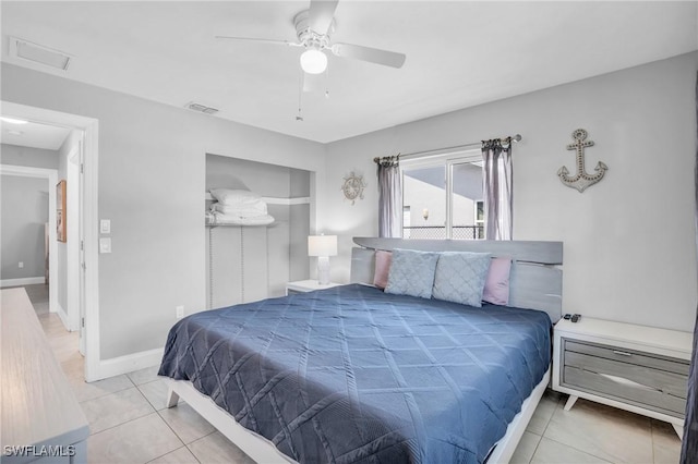 tiled bedroom featuring ceiling fan