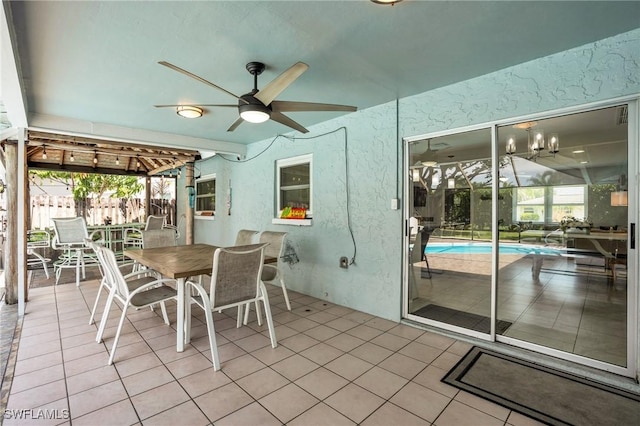 unfurnished sunroom featuring ceiling fan and plenty of natural light