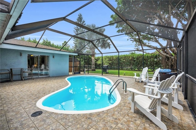 view of swimming pool featuring a lanai and a patio area