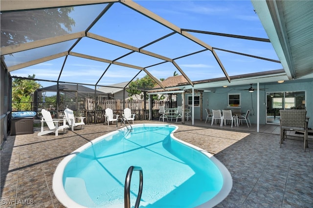 view of pool featuring ceiling fan, a patio area, and glass enclosure