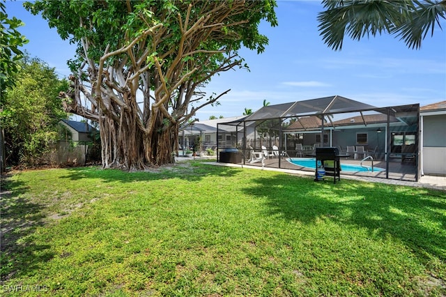 view of yard featuring glass enclosure and a patio area