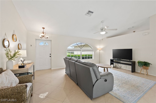 living room featuring ceiling fan with notable chandelier and lofted ceiling