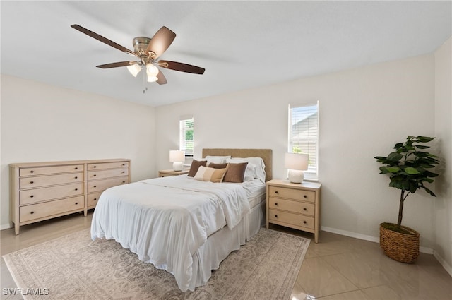 bedroom featuring multiple windows and ceiling fan