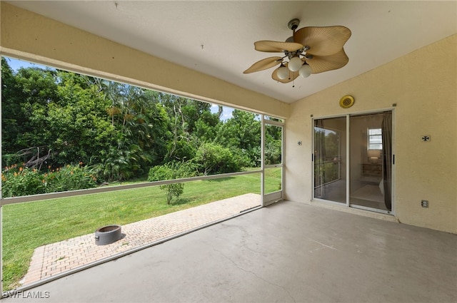 unfurnished sunroom featuring ceiling fan and vaulted ceiling