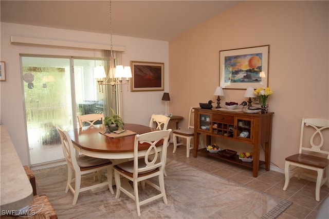 dining space featuring lofted ceiling, a notable chandelier, and tile patterned flooring