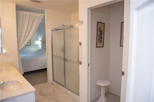 bathroom with vanity and a shower with shower door