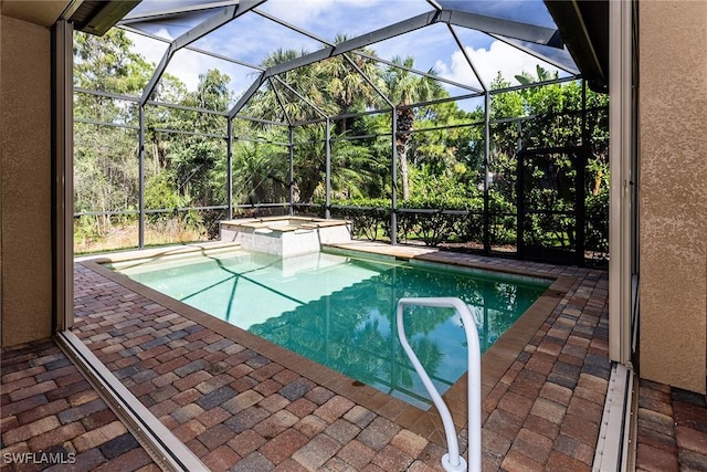 outdoor pool with glass enclosure, a patio area, and a jacuzzi