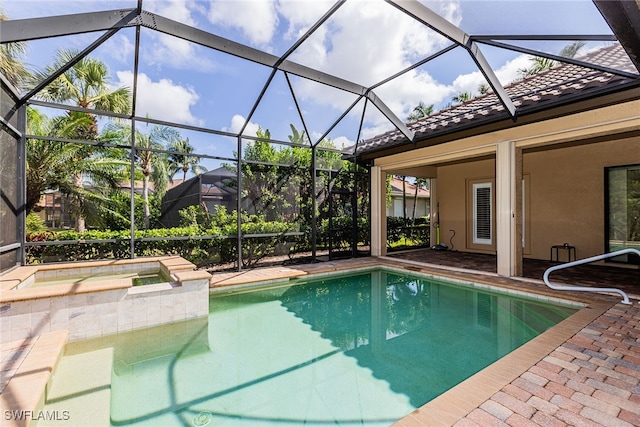 view of pool with glass enclosure and a patio area