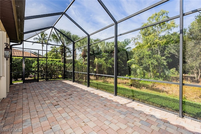 view of patio featuring glass enclosure