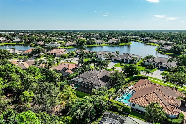 drone / aerial view with a water view and a residential view