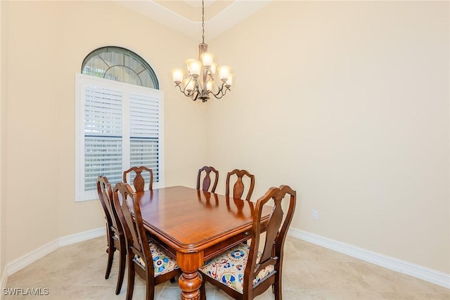 dining space with a notable chandelier, light tile patterned flooring, and baseboards