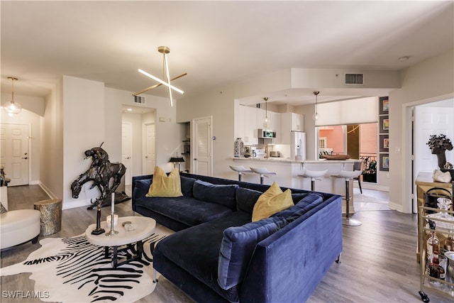 living room featuring light hardwood / wood-style flooring and a chandelier