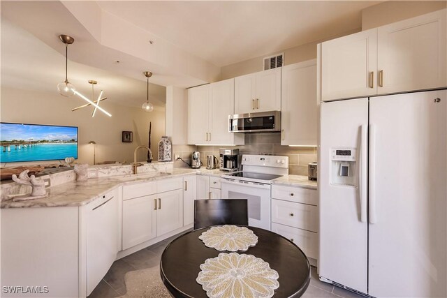 kitchen featuring decorative backsplash, sink, tile patterned floors, kitchen peninsula, and white appliances