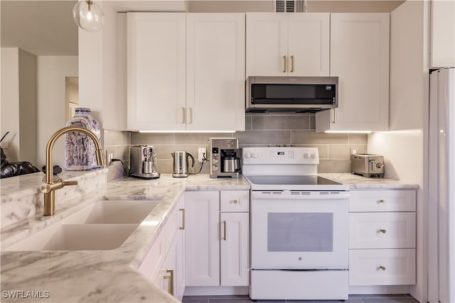 kitchen featuring decorative backsplash, white cabinetry, sink, light stone countertops, and white appliances