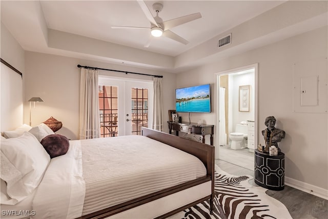 bedroom with hardwood / wood-style floors, french doors, access to outside, ensuite bathroom, and ceiling fan