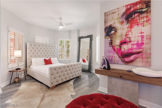 bedroom with ceiling fan and wood-type flooring