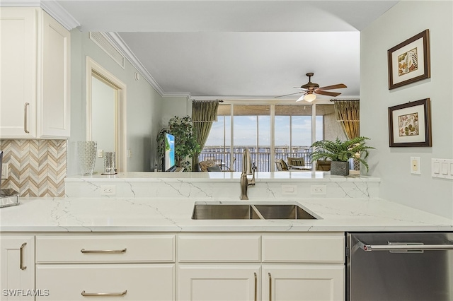 kitchen featuring light stone countertops, dishwasher, ceiling fan, sink, and ornamental molding